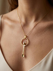 Lemurian Quartz fairy spoon pendant worn on a model with gold-plated brass and clear crystal point.