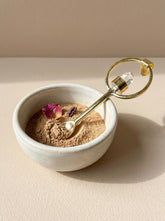 Lemurian Quartz gold-plated brass fairy spoon pendant shown beside a small bowl with warm ritual styling.