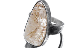 Close-up of tooth-shaped Clear Quartz ring showing Golden Rutile needle inclusions and oxidized silver bezel.