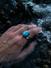 AAA Larimar sterling silver ring shown worn on hand with blue ocean stone and hammered silver band.