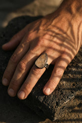 Golden Rutile Clear Quartz men’s ring in oxidized 925 sterling silver shown worn on the hand with hammered texture.