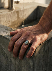 Australian Aquamarine ring shown worn outdoors, with square blue gemstone and rugged oxidized sterling silver band.