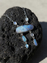 Australian Boulder Opal and Moonstone necklace shown on volcanic stone, with sterling silver wire link chain and Opal dangles.