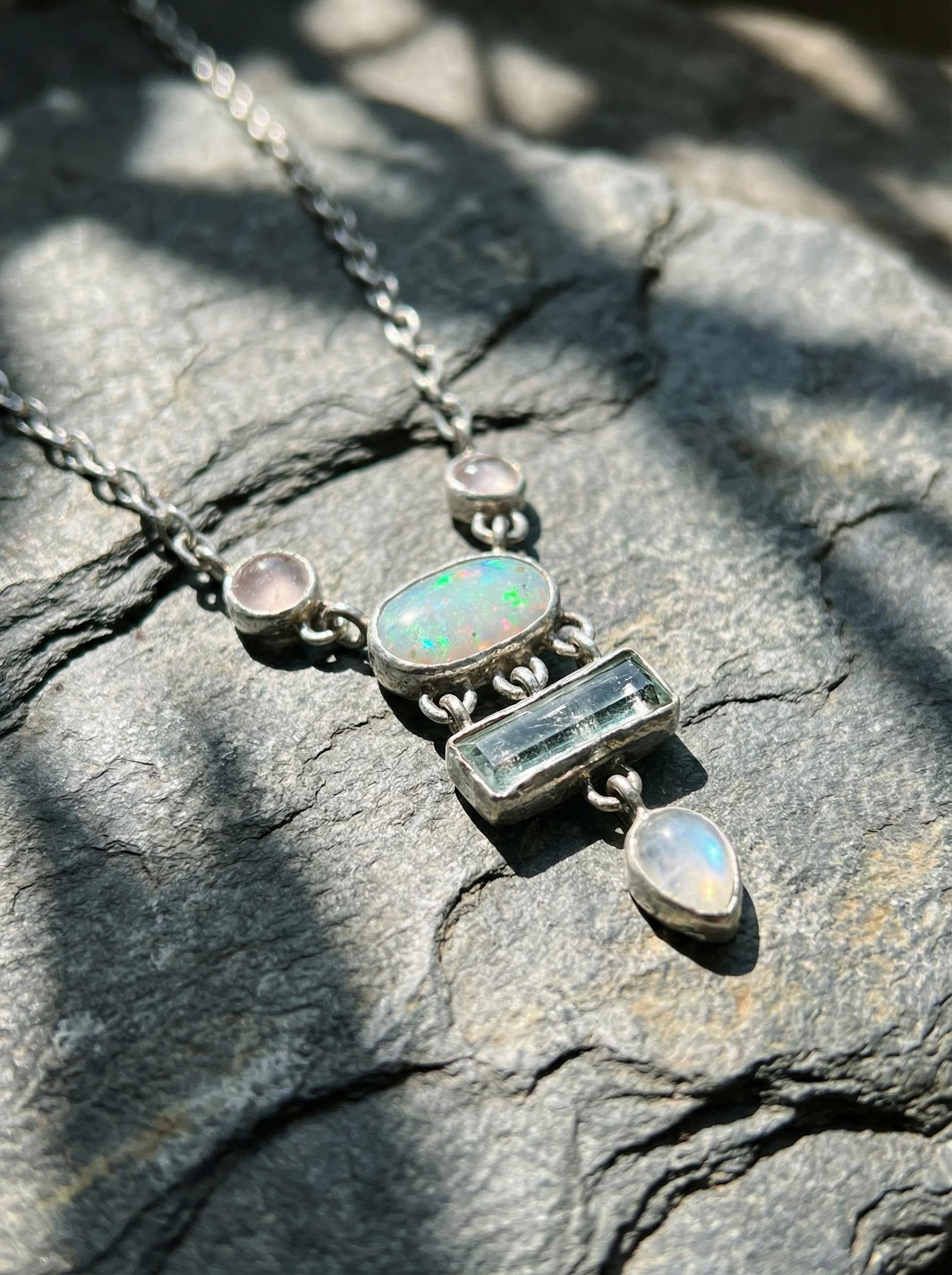Rose Quartz Opal Aquamarine Moonstone necklace shown worn on a model, with sterling silver box chain and soft gemstone layout.