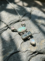 Rose Quartz Opal Aquamarine Moonstone necklace shown worn on a model, with sterling silver box chain and soft gemstone layout.