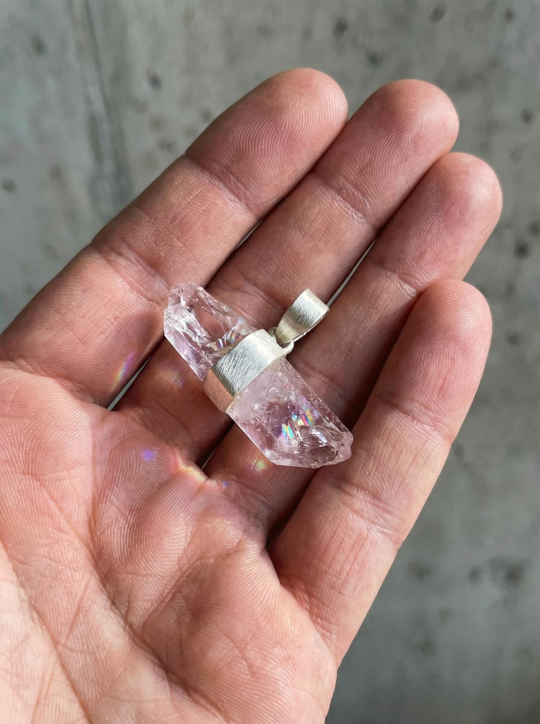 Double terminated Anhydro Vera Cruz Amethyst pendant held in hand with brushed sterling silver wrap.