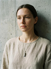 Lapis Lazuli sterling silver capsule pendant shown on model as a small keepsake talisman.