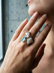 Celestial Tide multi-stone ring shown worn on the hand, with Herkimer Diamond, Pearl, and raw Blue Apatite in silver.