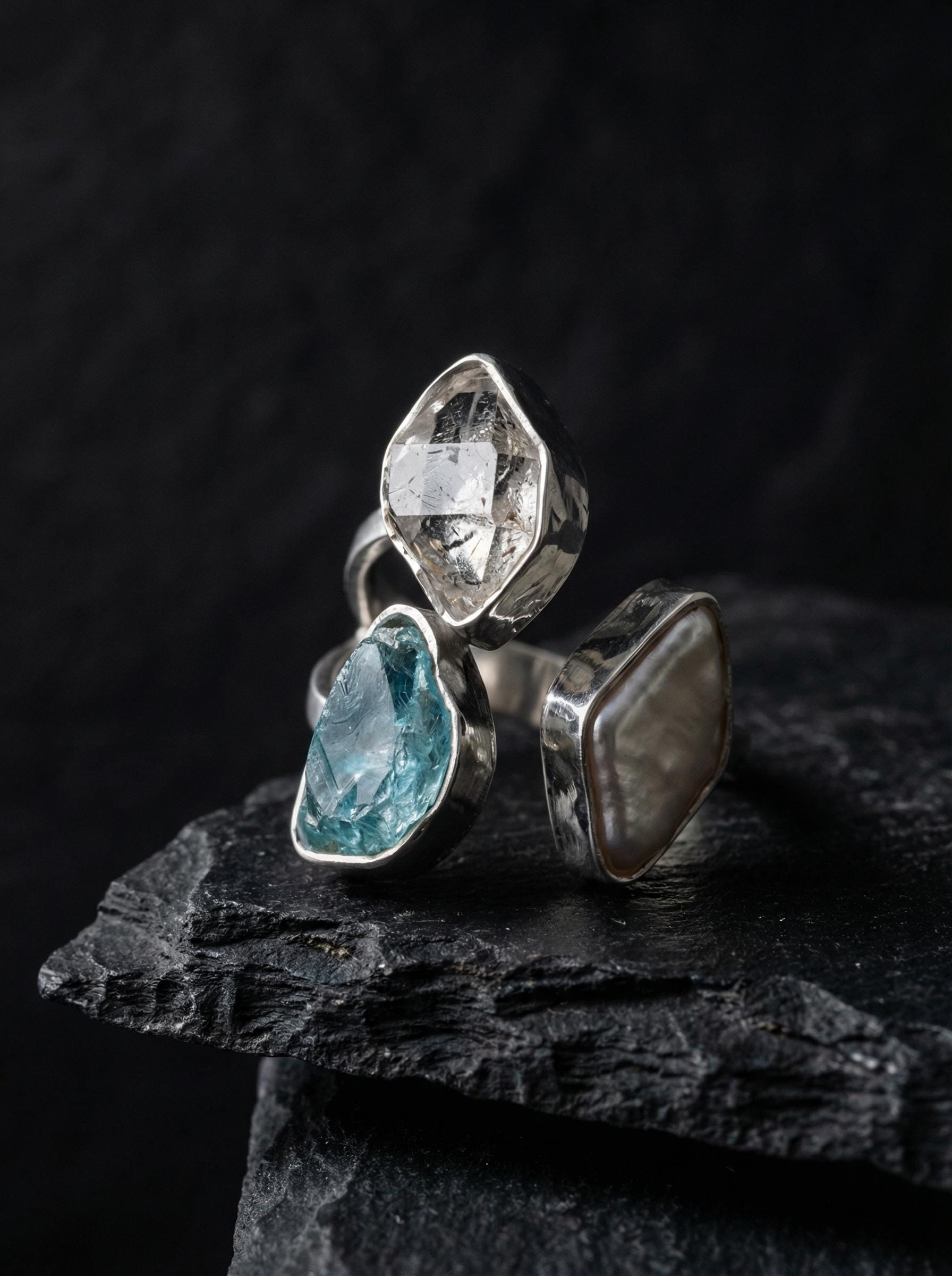 Herkimer Diamond Pearl Blue Apatite adjustable ring in high-shine 925 sterling silver shown on a dark stone background.