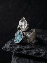Herkimer Diamond Pearl Blue Apatite adjustable ring in high-shine 925 sterling silver shown on a dark stone background.