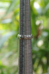 Hammered sterling silver ring shown on mandrel for US size 8 reference.