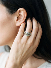 Peridot sterling silver ring shown on model as a sculptural five stone band.