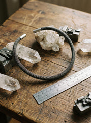 Sterling silver mesh choker displayed with crystals on wooden surface and ruler for size reference.