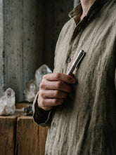 Sterling silver textured pen shown held in hand as a handmade luxury writing tool.