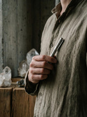 Sterling silver textured pen shown held in hand as a handmade luxury writing tool.