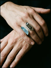 Tide and Shadow Smoky Quartz and Aquamarine Ring shown worn on hand with adjustable sterling silver dual stone setting.