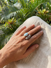 Horizon Flow Quartz and Larimar Ring shown worn on hand with adjustable sterling silver band and dual stone setting.