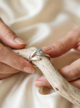 Dowsing Radiance Opal Ring shown held in hand with high-polish hammered sterling silver and Lightning Ridge Rainbow Opal.
