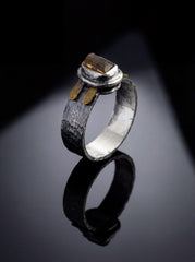 Brown Tourmaline Dravite Silver Ring shown on black background with rugged oxidized silver band and brass detail.