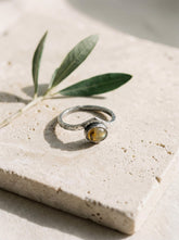 Golden Rainbow Labradorite Band Ring shown on white background with oval Labradorite and refined silver band.