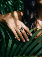 Elemental Black Tourmaline Ring shown worn on hand with hammered sterling silver band and raw double-terminated crystal.