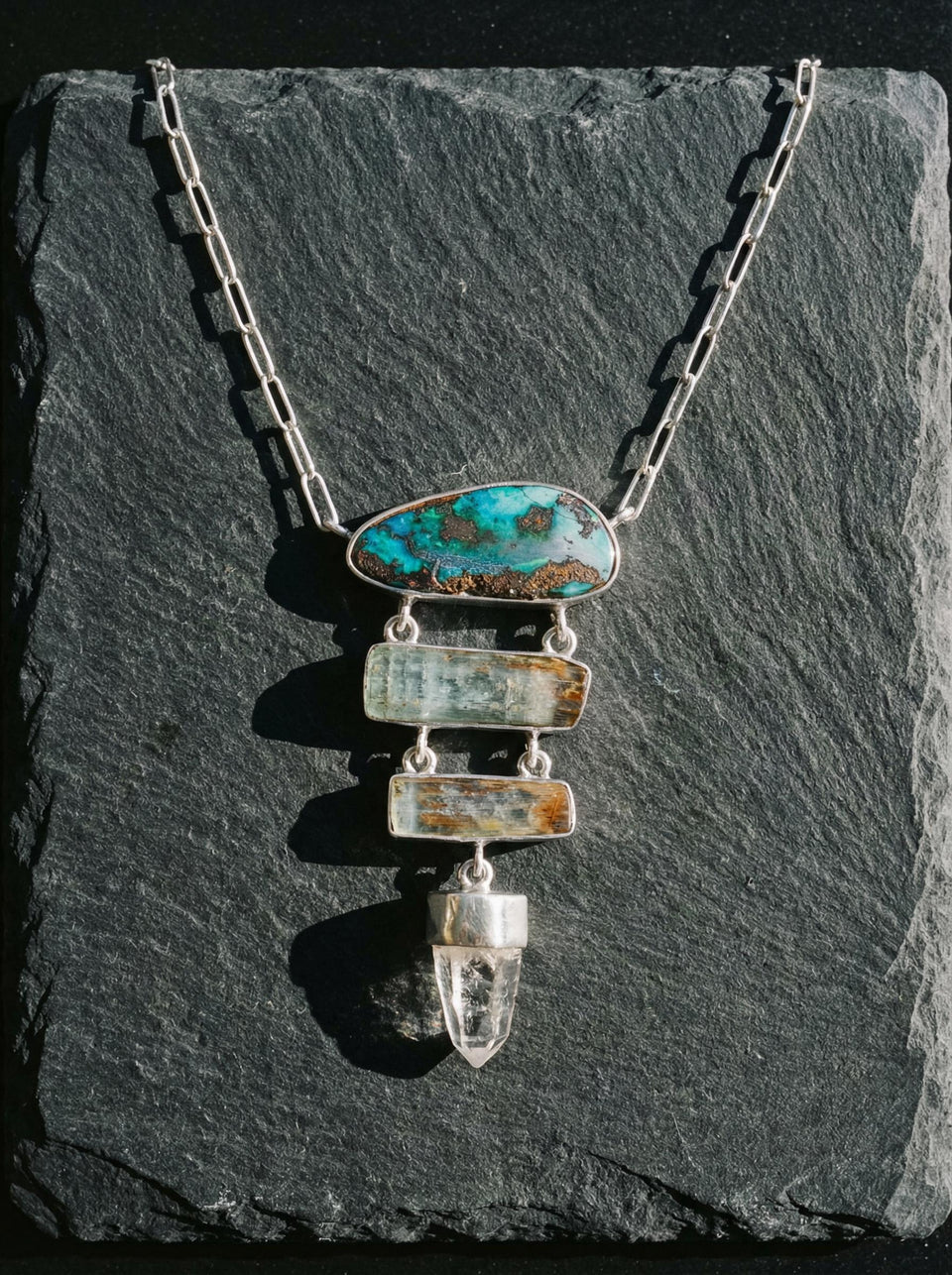 Australian Boulder Opal Aquamarine Lemurian Quartz pendant shown on slate, with all-Australian stones and sterling silver setting.