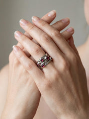Garnet sterling silver ring shown worn on hand as a sculptural five stone band.
