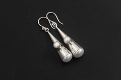 Sterling silver Pearl cone earrings displayed on dark background with fish hook ear wires.