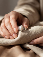 Lunar Gleam Marquise Pearl Ring shown worn on hand with hammered sterling silver band and elongated Pearl centre.