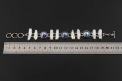 Pearl sterling silver bracelet shown beside a ruler for approximately 22 cm length reference.