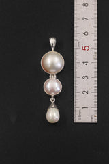 Triple Pearl sterling silver pendant shown beside a ruler 5.5cm for vertical pendant size reference.