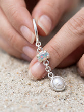Ethiopian Opal and Pearl hoop earrings in 925 sterling silver shown close-up with claw-set Opal charms and Pearl dangles.