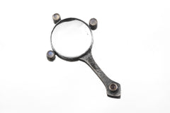 Moonstone magnifier pendant displayed on white background with hammered oxidized silver handle and glass lens.