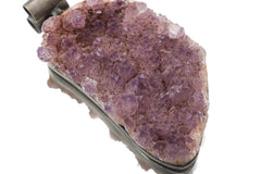 Close view of raw Amethyst cluster pendant showing dense purple druzy crystals and organic shape.