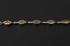 Close view of Citrine bracelet showing faceted golden stones and articulated sterling silver links.