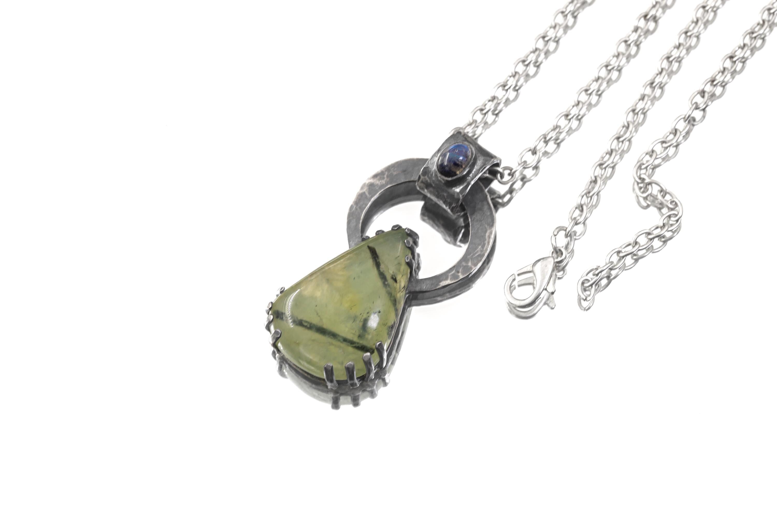 Blue Moonstone Peridot heirloom pendant shown on white background with oxidized sterling silver brutalist claw setting.