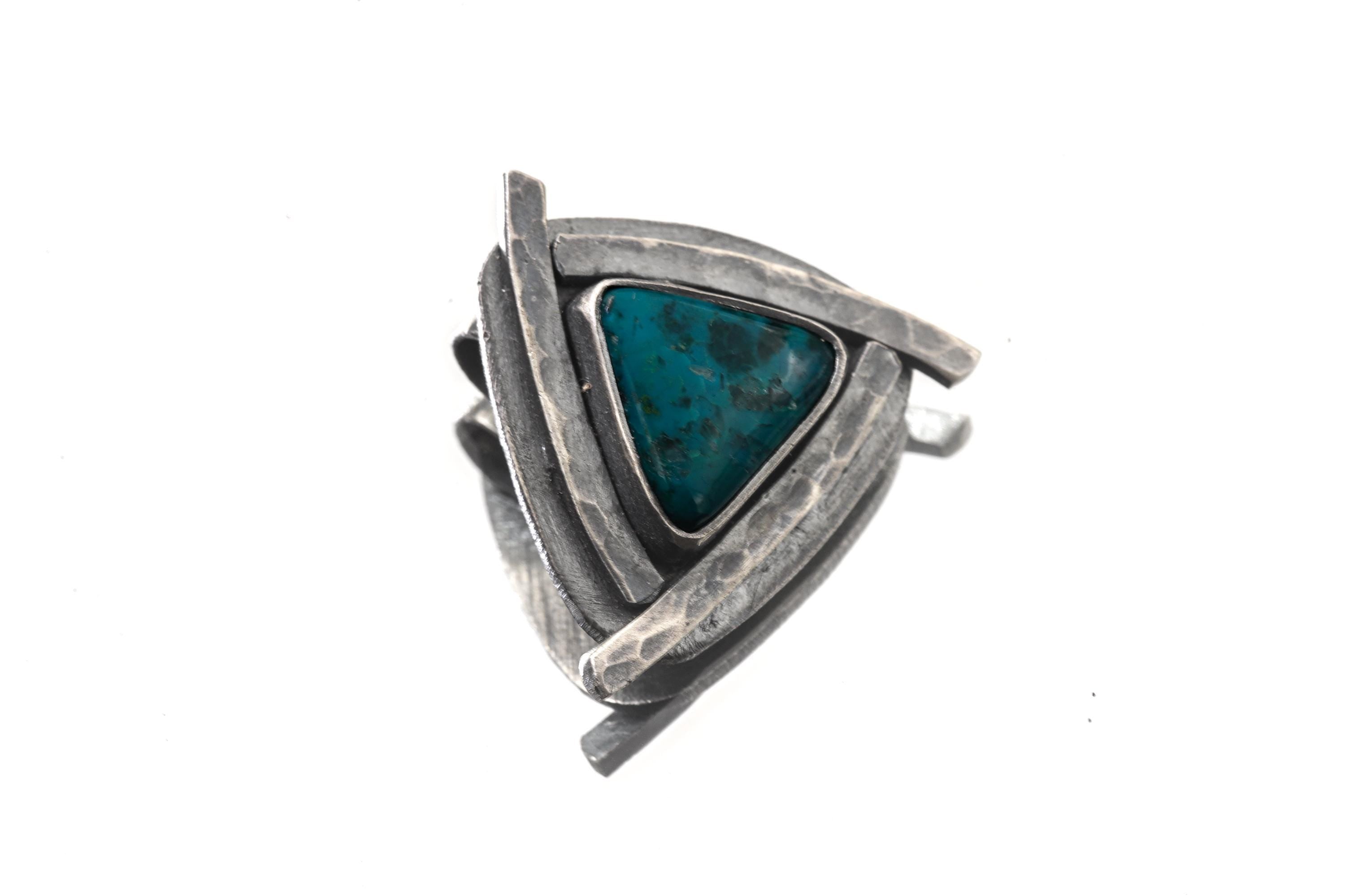 Chrysocolla triangle pendant shown on white background with oxidized sterling silver and hammered sun-ray detail.