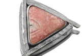 Rhodochrosite triangle pendant shown close-up with oxidized sterling silver and hammered sun-ray detail.