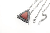 Rhodochrosite triangle pendant shown with chain on white background in oxidized sterling silver sun setting.