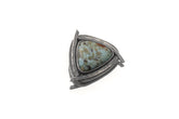 Larimar triangle pendant shown with chain on white background in oxidized sterling silver sun setting.