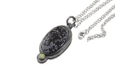 Dalmatian Jasper Ethiopian Opal sun pendant shown with sterling silver chain and textured handmade silver setting.