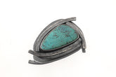 Australian Chrysocolla triangle pendant shown on white background with oxidized sterling silver sun-ray detailing.