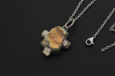 Labradorite Moonstone sterling silver pendant shown with chain on black background and raw multistone setting.