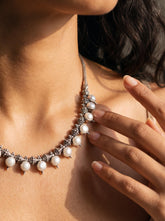 Pearl sterling silver necklace shown worn on model with luminous white Pearls and oxidized silver beadwork.