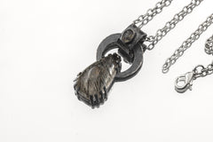 Blue Moonstone Black Rutile Quartz pendant on white background with oxidized sterling silver claw setting and chain.