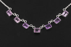 Close view of square Amethyst necklace showing lilac and violet stones in polished sterling silver bezels.