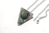 Turquoise triangle pendant shown with sterling silver chain and oxidized hammered silver setting.