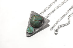 Turquoise triangle pendant shown with sterling silver chain and oxidized hammered silver setting.