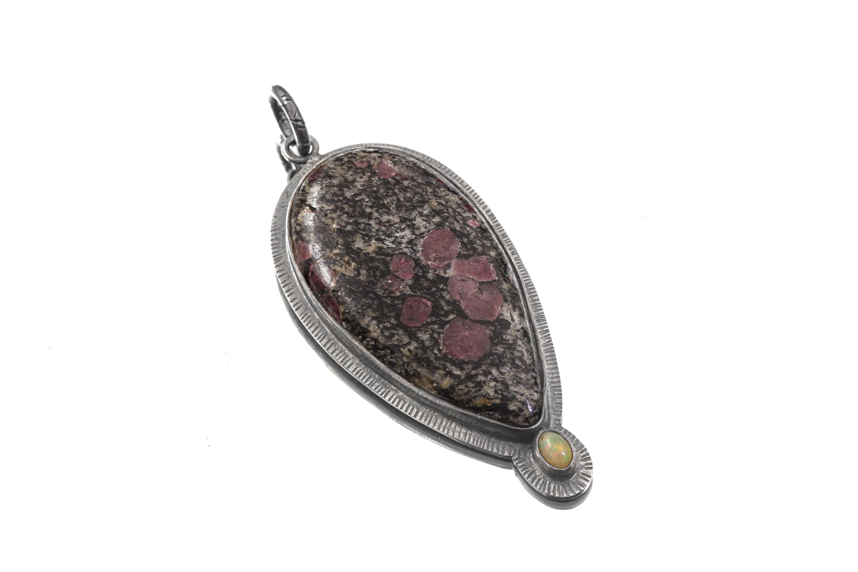 Ruby in Black Matrix Ethiopian Opal sterling silver pendant shown with chain and sun-inspired handmade silver setting.