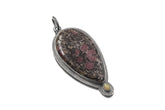 Ruby in Black Matrix Ethiopian Opal sterling silver pendant shown with chain and sun-inspired handmade silver setting.